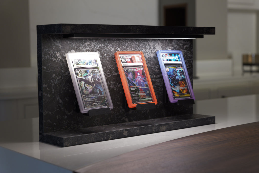 Slab Stand Obsidian graded card display stand with three PSA slabs under LED light